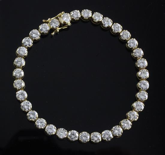 An 18ct gold and diamond line bracelet, 18cm.